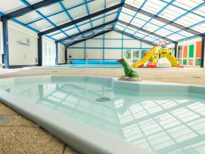 a glass table with a toy frog sitting on top of it at Vakantiepark 't Strandheem in Opende