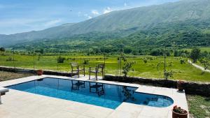 a swimming pool with a view of a mountain at Nora's Chalet in Fshati i Ri