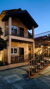 a building with a balcony on the side of it at Velora The Luxury Resort in Māndu