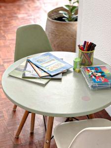 a white table with books and magazines on it at Di Vine in Maputo +51 photos