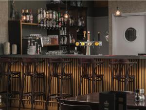 a bar in a restaurant with bar stools at Vakantiepark 't Strandheem in Opende