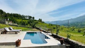 a swimming pool with a view of a mountain at Nora's Chalet in Fshati i Ri +18 photos