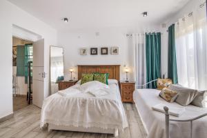 a bedroom with two beds and a mirror at El Encanto in Villarrasa +25 photos