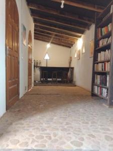 an empty room with a piano and a book shelf at Nougouranch in Rufisque