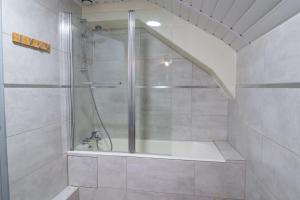 a shower with a glass door in a bathroom at Gîte de marthe in Sainte-Colombe-de-Peyre +26 photos