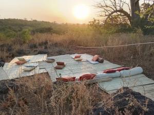 a group of pillows on a wooden table in a field at Nougouranch in Rufisque