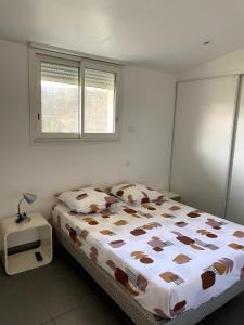 a bedroom with a bed and a window at Villa kaja in Saint-Porchaire