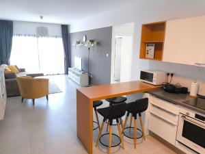 a kitchen with a counter and stools in a room at Caesar Blue Resort & Spa apartment I-66 in Kalecik