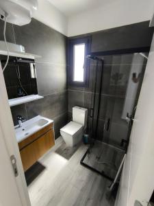 a bathroom with a toilet and a sink and a shower at Caesar Blue Resort & Spa apartment I-66 in Kalecik +12 photos
