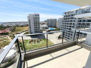 an apartment balcony with a view of a city at Caesar Blue Resort & Spa apartment I-66 in Kalecik