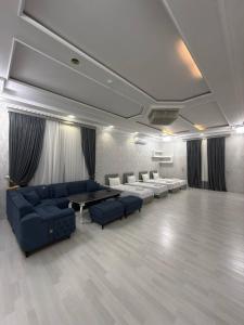 a living room with couches and a table and chairs at Global Star Hotel in Samarkand +54 photos