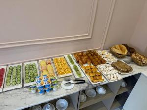 a buffet of different types of food on a shelf at Global Star Hotel in Samarkand