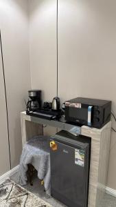 a desk with a computer and a printer on it at شقق مرفا in Hail