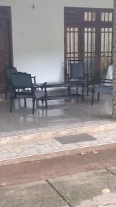a group of benches sitting in a room at The banglow homestay in Anuradhapura