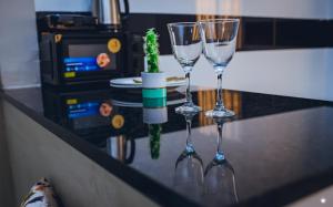 a couple of wine glasses sitting on a counter at Residencial Biva in Namibe