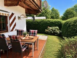 a patio with a table and chairs in a yard at CHALET BELLE KITZ by Belle Stay in Kitzbühel