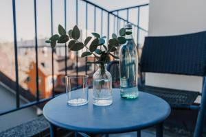 un tavolo con due bicchieri, una bottiglia e un vaso di Hotel Boulevard a Costanza