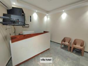 a waiting room with two chairs and a counter at new Villa117 in Cairo