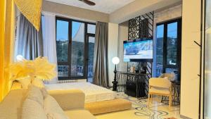 a bedroom with a bed and a flat screen tv at Inn OZZ Almaty in Almaty
