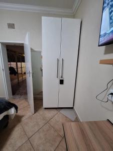 a room with a white cabinet in a room at Rams Blissful Guest House in Rustenburg