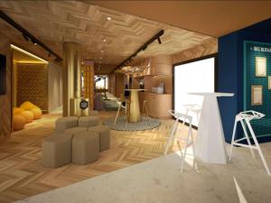 a living room with a couch and chairs and a table at IBIS BUDGET GUINGAMP in Ploumagoar