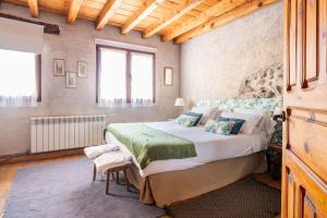 a bedroom with a large bed in a room at Casa Valle del Lozoya in Rascafría