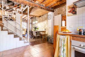 a kitchen with a staircase and a dining room at Casa Valle del Lozoya in Rascafría