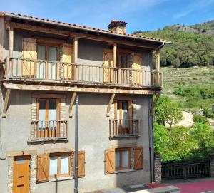 a building with balconies on the side of it at Cal Abel in Gombreny
