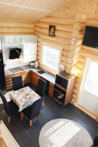 a kitchen with a table and chairs in a room at HIMOS Petäjäkuja 3 in Himos