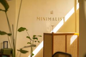 a room with a table with a sign that reads mindfulness at Minimalist Panjim in Panaji