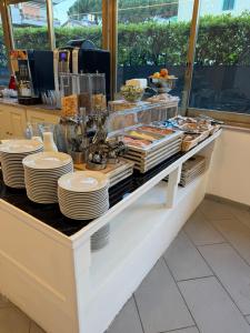 a buffet with plates and food on a counter at Terme Palace Hotel in Montecatini Terme