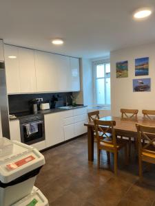 a kitchen with a table and a dining room at Travellers' Haven Hostel in Bled
