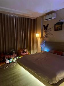 a bedroom with a large bed and a window at AN BÌNH Home in Hai Phong
