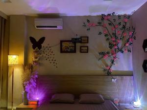 a room with a bed with flowers on the wall at AN BÌNH Home in Hai Phong