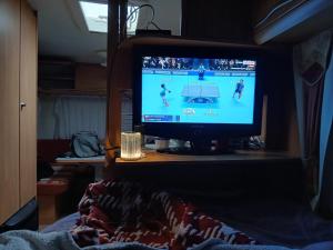 a television sitting on a table in a bedroom at La Ventana - Jardin & Parking in Étretat