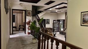 a staircase in a house with a living room at Adams Lodge F-7 in Islamabad