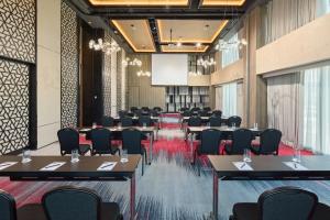 a conference room with tables and chairs and a screen at Radisson RED Cebu Mandaue in Cebu City +65 photos
