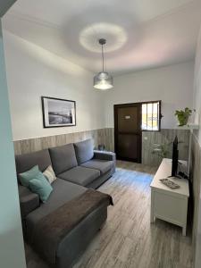 a living room with a couch and a table at Hostjimeno Invierno in La Garita