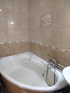 a bath tub with a faucet in a bathroom at Letto UTZ in Mykolaiv