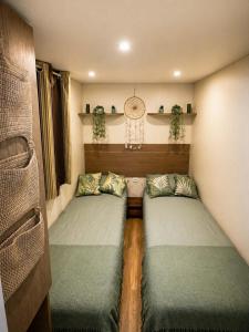a room with two beds in a room at Domki Na Ranczo in Gniezno