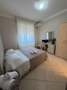 a bedroom with a bed with towels on it at Terme Palace Hotel in Montecatini Terme