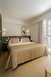 a bedroom with a large bed with two pillows at Cabot Cap de Mar Spa in Cala Bona +83 photos