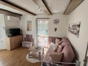 a living room with a couch and a tv at Mały cichy zakątek in Ciechocinek