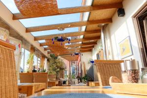 a dining room with a ceiling with wooden beams at B&B Fischerstüble - adults only in Hagnau