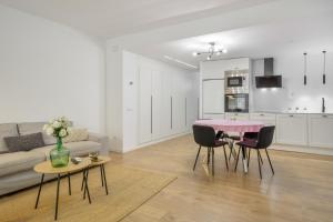 a living room with a couch and a table and chairs at Myholidayshome in Palamós