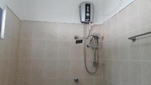 a shower in a bathroom with a shower head at Wild View Stay in Habarana