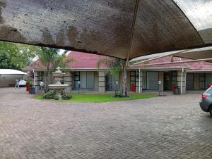a courtyard with a fountain in front of a building at Vukani Holdings Group in Vanderbijlpark