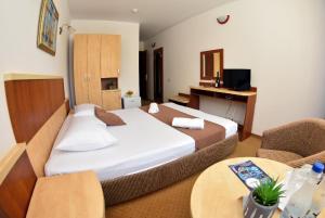 ein Hotelzimmer mit einem Bett und einem Tisch in der Unterkunft Hotel Ammos Neptun in Neptun + 43 Fotos