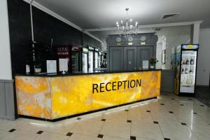 a yellow counter with the word reception on it at ALCAZAR in Atyrau