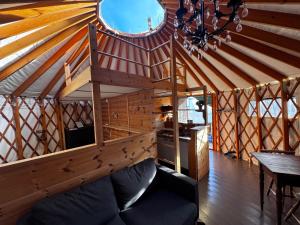 a large wooden room with a couch in a yurt at Halvorseth in Prestfoss